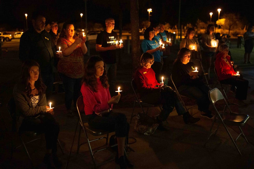 Community members listen to family members of those who died via road traffic accident during a vigil for road traffic victims on Friday, Nov. 17, 2023, at Centennial High School.