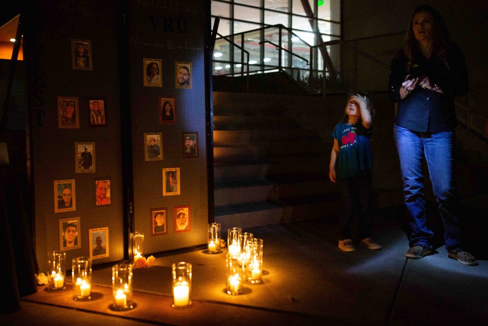 A family waits for a vigil for road traffic victims to begin on Friday, Nov. 17, 2023, at Centennial High School.