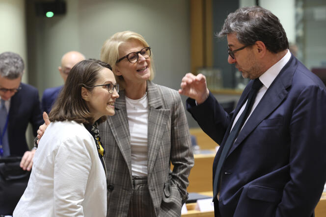 Italian Finance Minister Giancarlo Giorgetti, right, speaks with Dutch Finance Minister Sigrid Kaag, center, during a round table meeting of EU finance ministers at the European Council building in Brussels, Tuesday, May 16, 2023.