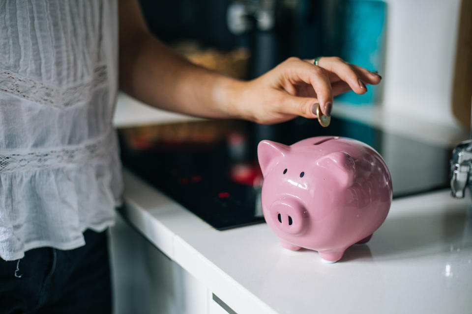 Savings accounts  Woman saving money in a piggybank