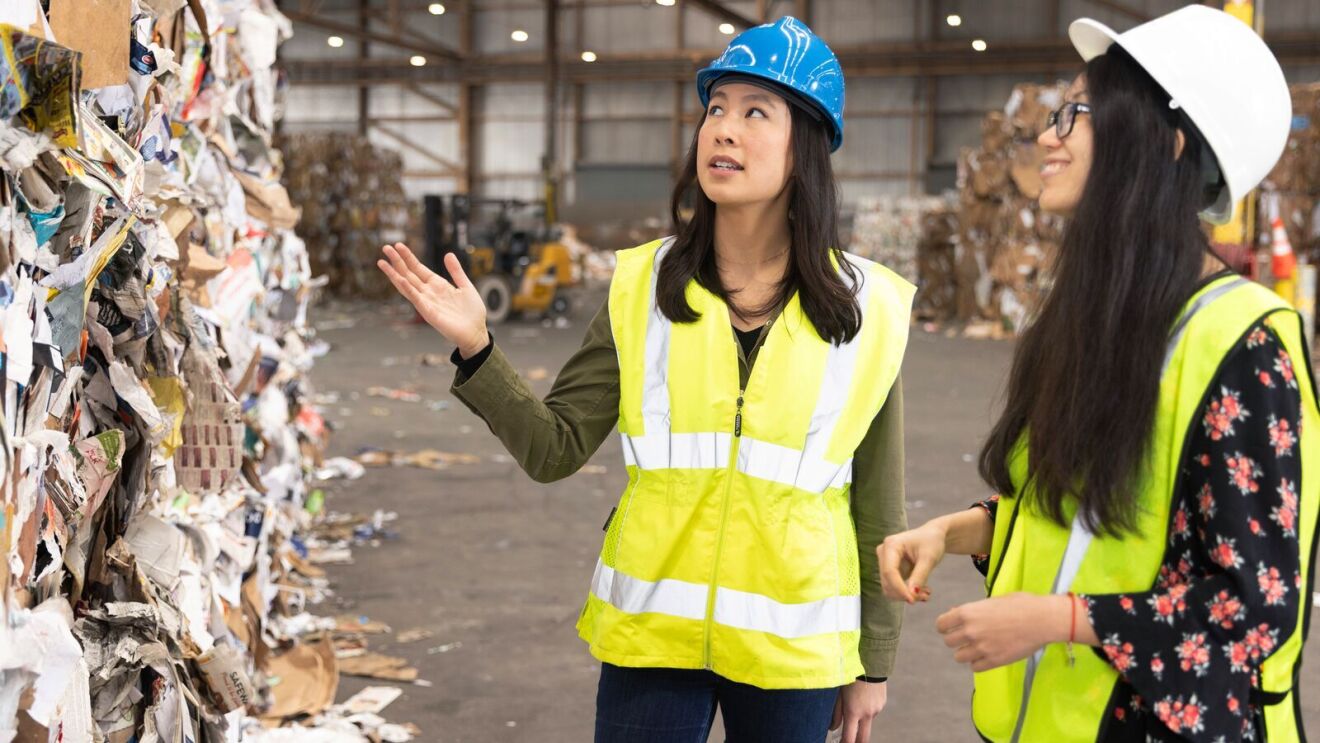 Rebecca Hu and Phoebe Wang take a closer look at paper ready to be recycled at a Materials Recovery Facility in San Francisco.
