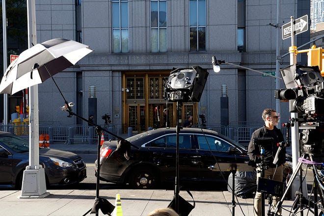 Memebers of the press stand outside of the Worth Street entrance of the Patrick Moynahan Federal Courhouse on October 26, 2023 in New York City. Sam Bankman-Fried, founder of the collapsed cryptocurrency exchange FTX, plans to make another high-stakes gamble and testify in his own defense at his criminal fraud trial.