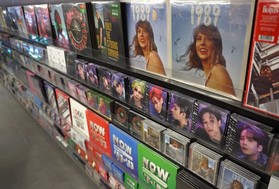 a stand of vinyl records, with one of Taylor Swift's prominently highlighted