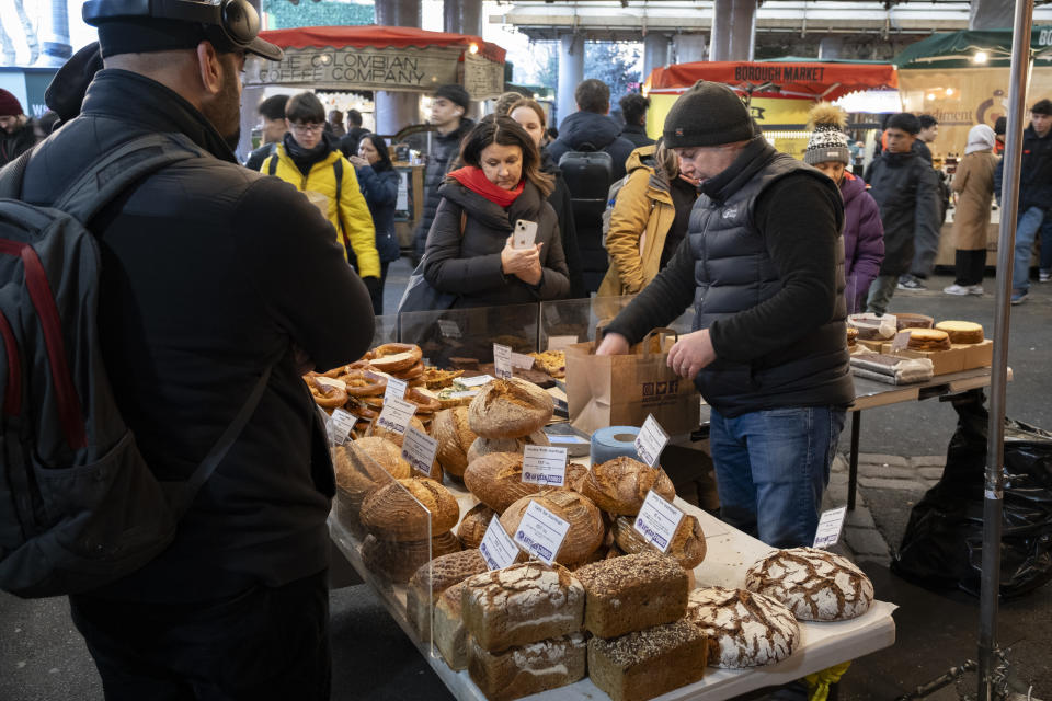 inflation Market trader serving customers on his bread stall in Borough Market on 16th January 2024 in London, United Kingdom. Borough Market is a retail food market and farmers market in Southwark. It is one of the largest and oldest food markets in London, with a market on the site dating back to at least the 12th century. A farmers market is a physical retail marketplace intended to sell foods directly by farmers to consumers. (photo by Mike Kemp/In Pictures via Getty Images)