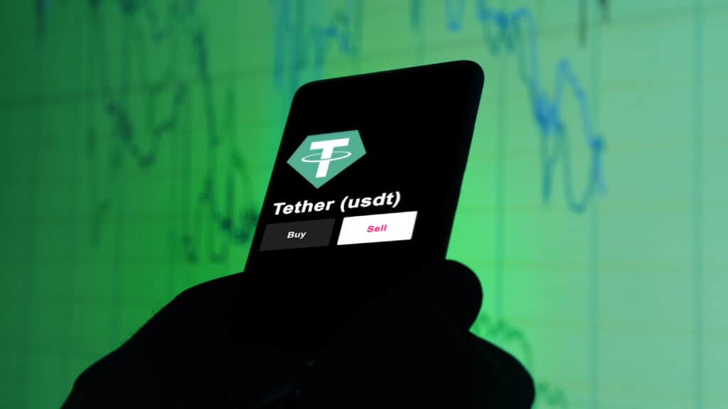tether usdt coin on phone screen