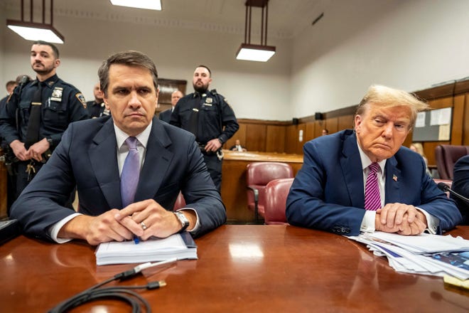 Former U.S. President Donald Trump and lawyer Todd Blanche sit in the Manhattan Criminal Court before the start of his trial for allegedly covering up hush money payments in New York City, U.S., April 19, 2024.