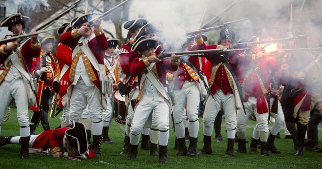 Re-enactors of the Battle of Lexington dressed as British soldiers fire their weapons as they battle with the Lexington militia April 17, 2006 in Lexington, Massachusetts. The Battle of Lexington, which took place in 1775, was the first skirmish of the Revolutionary War.