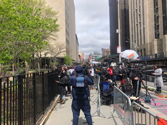 Members of media are seen moments after a person reportedly self-immolated outside the Manhattan Criminal Court in New York on April 19, 2024.