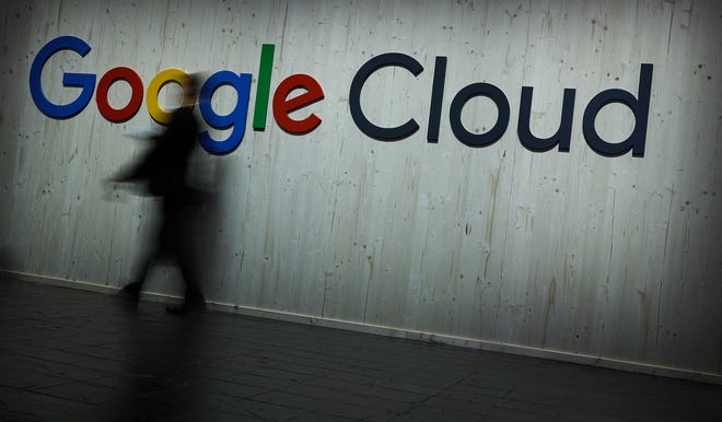 A visitor walks past a Google Cloud sign in Hanover, Germany