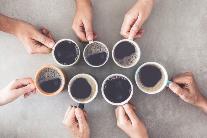 People holding cups of coffee