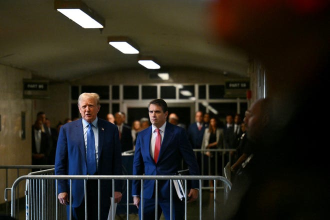 Former US President Donald Trump, with lawyer Todd Blanche, speaks to the press before his trial for allegedly covering up a hush money payment linked to an extramarital affair at Manhattan Criminal Court in New York City, on May 9, 2024. X-rated film actress Stormy Daniels is to return to the witness stand on Thursday at Trump's hush money trial for another round of expected tough grilling by a lawyer for the former president.