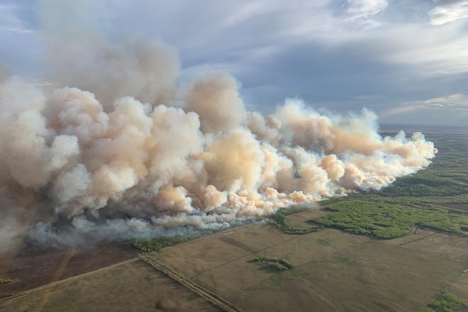 Smoke rises from mutual aid wildfire GCU007 in the Grande Prairie Forest Area near TeePee Creek, Alberta, Canada May 10, 2024.