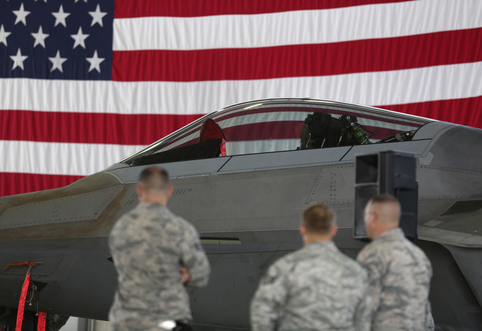 Soldiers stand in front of an U.S. Air Force F-22 Raptor fighter jet during a briefing in a hangar at the U.S. Spangdahlem Air base, Germany September 3, 2015.  REUTERS/Ina Fassbender