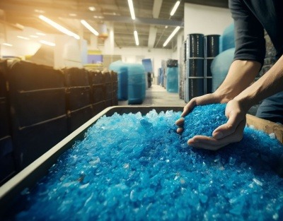 Blue plastic flakes of recycled plastic to be used in industrial manufacturing