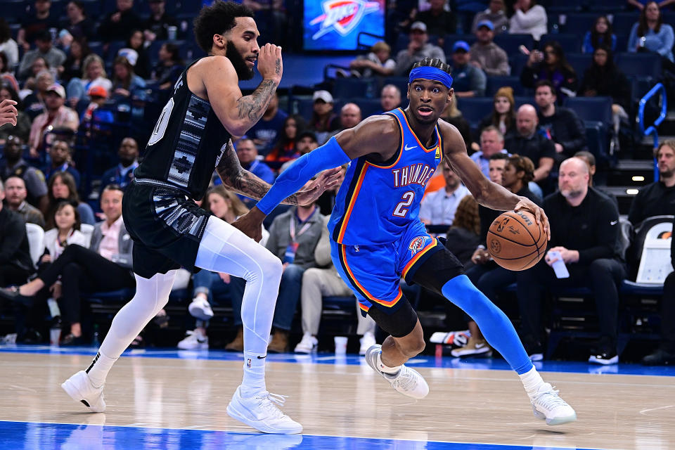 Shai Gilgeous-Alexander of the Oklahoma City Thunder drives against Julian Champagnie of the San Antonio Spurs at Paycom Center on April 10, 2024 in Oklahoma City.  (Photo by Joshua Gateley/Getty Images)
