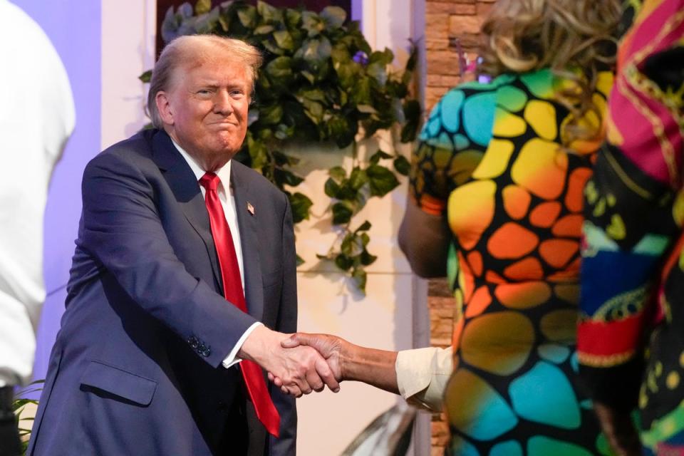 Scammers registered domains with common misspellings to lure in Trump supporters intending to visit donaldjtrump.com to donate crypto. Pictured: Trump at a gathering in a Detroit church (AP)