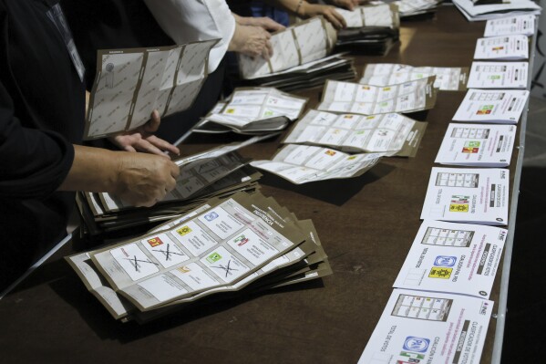 Electoral officials count ballots after polls closed during general elections in Mexico City, Sunday, June 2, 2024. (AP Photo/Ginnette Riquelme)