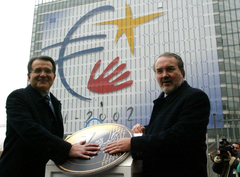 Romano Prodi and EU Commissioner for Monetary Affairs Spanish Pedro Solbes pose next to a giant euro coin on December 31, 2001, hours before the official launch of the currency. Photo: AFP