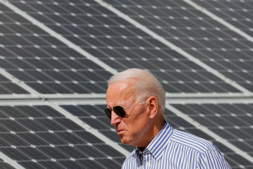 Democratic 2020 U.S. presidential candidate and former Vice President Joe Biden walks past solar panels while touring the Plymouth Area Renewable Energy Initiative in Plymouth, New Hampshire, U.S., June 4, 2019.   REUTERS/Brian Snyder