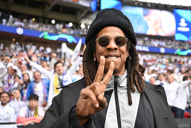 Jay-Z gestures ahead of the UEFA Champions League final football match between Borussia Dortmund and Real Madrid, at Wembley stadium, in London.