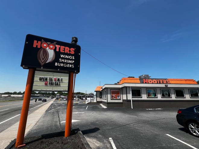 While the sign outside the Hooters on Airport Road in Warwick, Rhode Island indicates hours of operation, signs on the door note the restaurant has closed indefinitely.