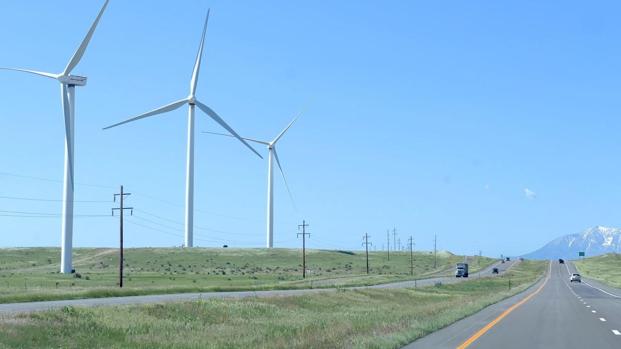 Wind Turbines Alongside a Highway with Mountain Views in Colorado