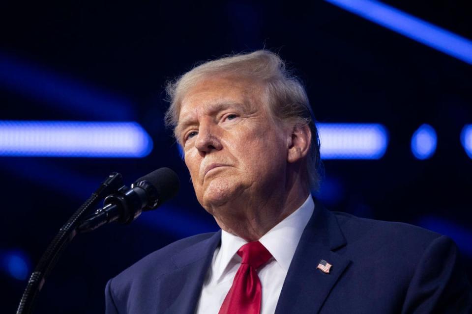 Donald Trump speaks at a Turning Point USA conference on June 15. Now, crypto scammeras are going after his supporters with a new hoax. (Getty Images)