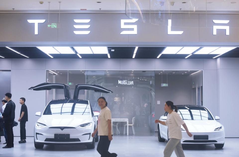 ftse HANGZHOU, CHINA - JUNE 4, 2024 - Customers walk past a Tesla store in Hangzhou, Zhejiang province, China, June 4, 2024. (Photo credit should read CFOTO/Future Publishing via Getty Images)