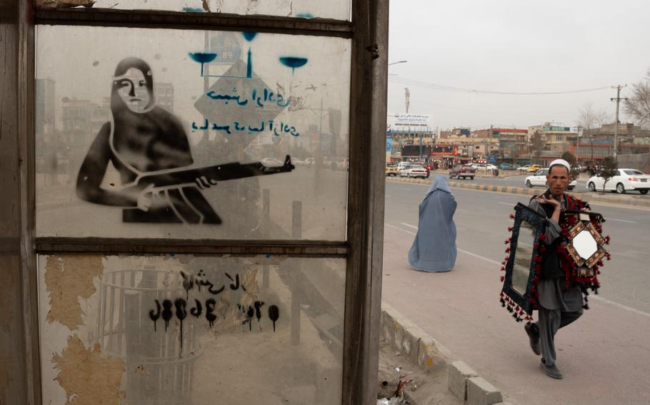 A man walks by a bus stop in Kabul, Afghanistan, February 2021, months before international forces left the country. A government watchdog agency said this week that U.S. funds could have ended up funding extremists in Afghanistan because two State Department bureaus didnt comply with regulations for vetting aid recipients.