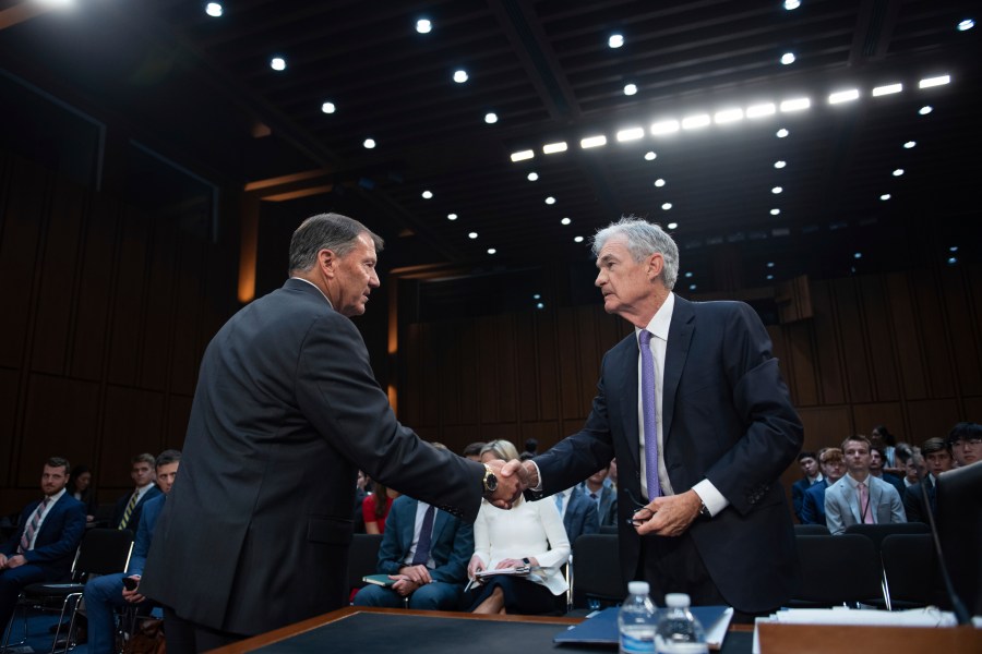 Chair of the Federal Reserve of the United States Jerome Powell shakes hands with United States Senator Mike Rounds (Republican of South Dakota) at a hearing for the Committee on Banking, Housing, and Urban Affairs to present 