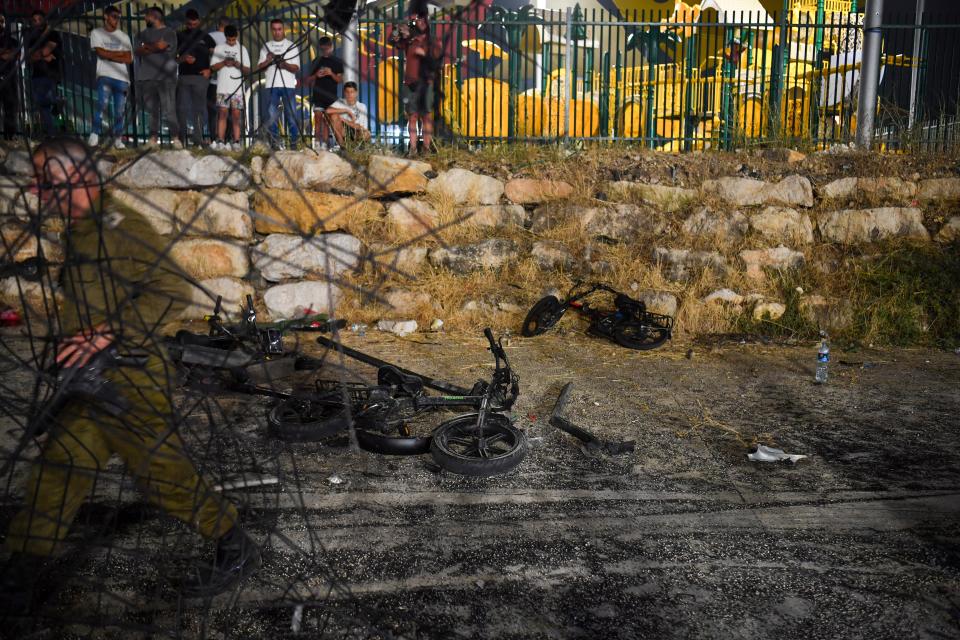 Destroyed children's bicycles at the site of a rocket attack in the Druze town of Majdal Shams, in the Israeli-controlled Golan Heights (AP)