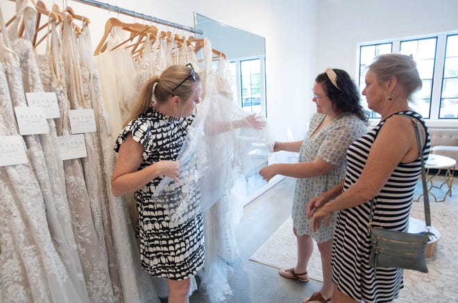 Bride Kimberly “Kiki” Waldrop, of Atmore, Alabama, shops for dresses with her mother Rhonda Barrow, left, and grandmother Kathy Rolin at Bliss Bridal in Fairhope, Alabama on Thursday, June 20, 2024.