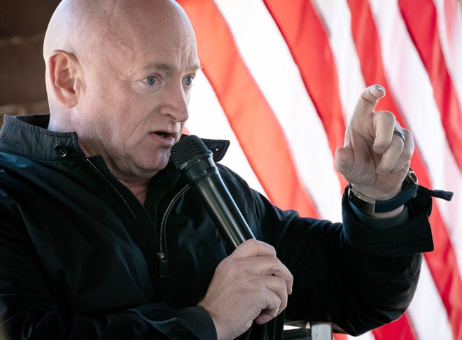 U.S. Senator Mark Kelly answers a question during a news conference on Jan. 18, 2022, in the Binns Wildflower Pavilion at the Desert Botanical Garden in Phoenix.