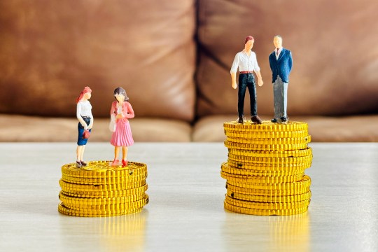 An illustration highlighting the gender pay gap, with men and women on coins