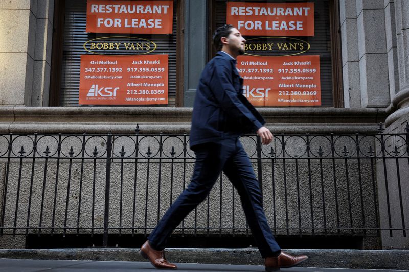 © Reuters. FILE PHOTO: A man walks past 