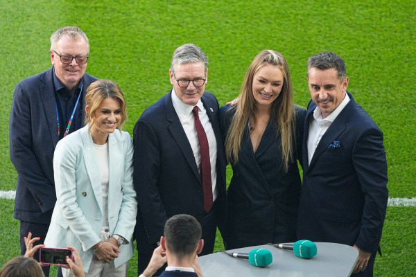 Sir Keir pictured with Karen Carney, Laura Woods and Gary Neville standing on a football pitch