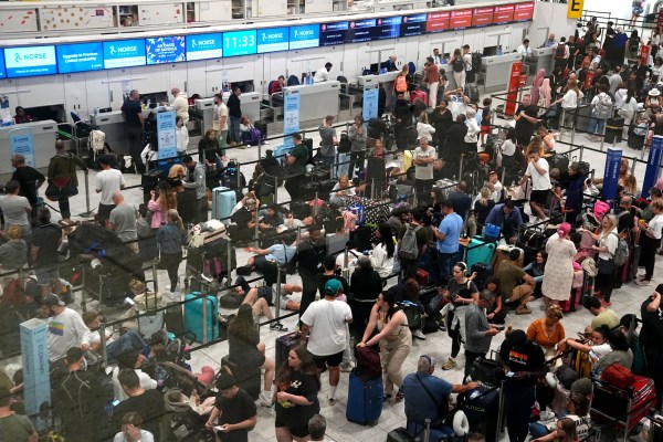 Passengers in the South Terminal at Gatwick Airport in Crawley, east Sussex, amid reports of widespread IT outages affecting airlines, broadcasters and banks. Picture date: Friday July 19, 2024. PA Photo. See PA story TECHNOLOGY Outage. Photo credit should read: Aaron Chown/PA Wire